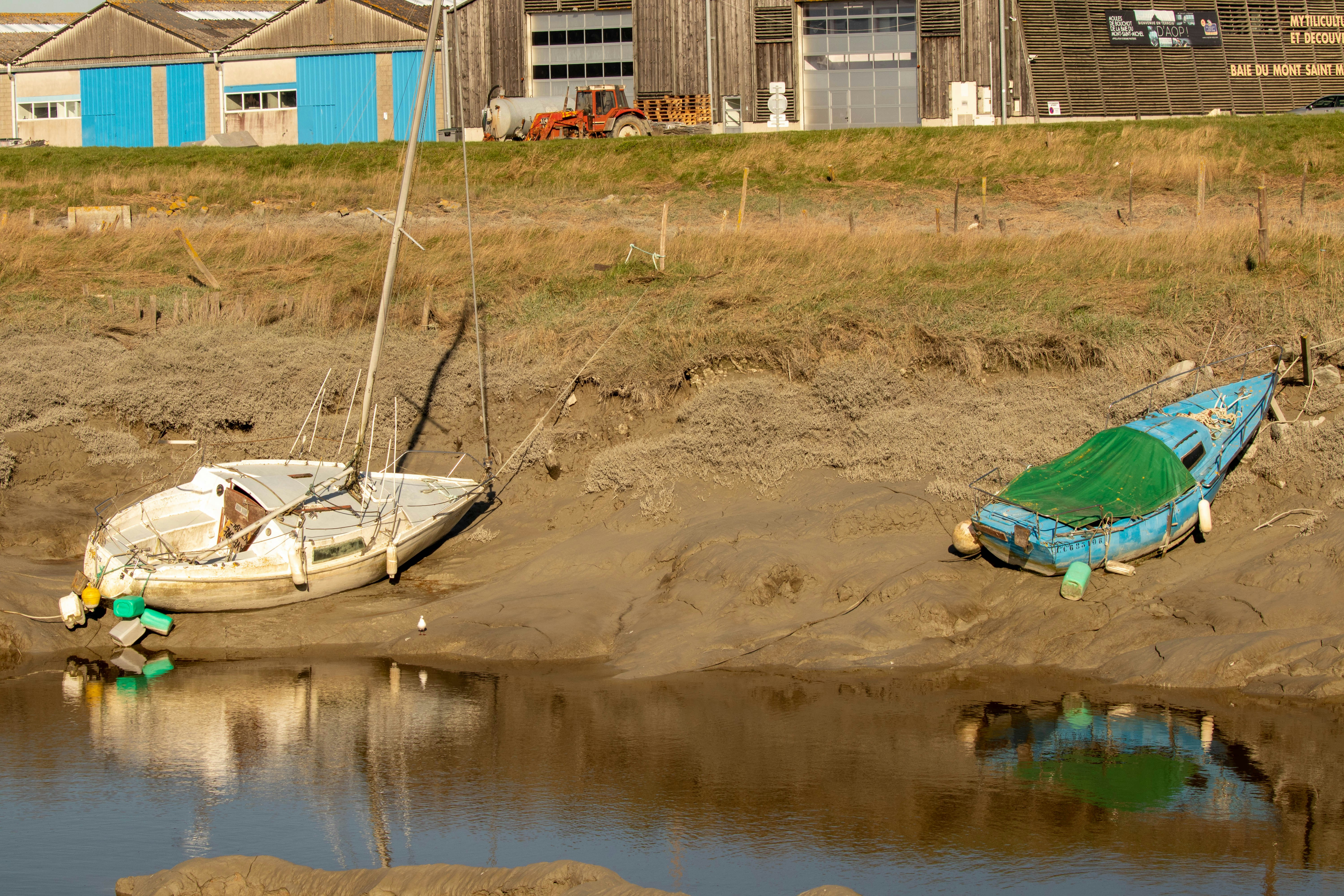 a couple of boats that are sitting in the sand