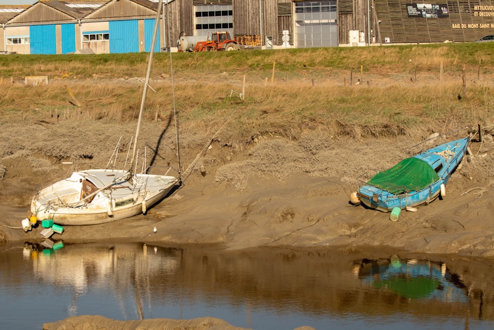 a couple of boats that are sitting in the sand
