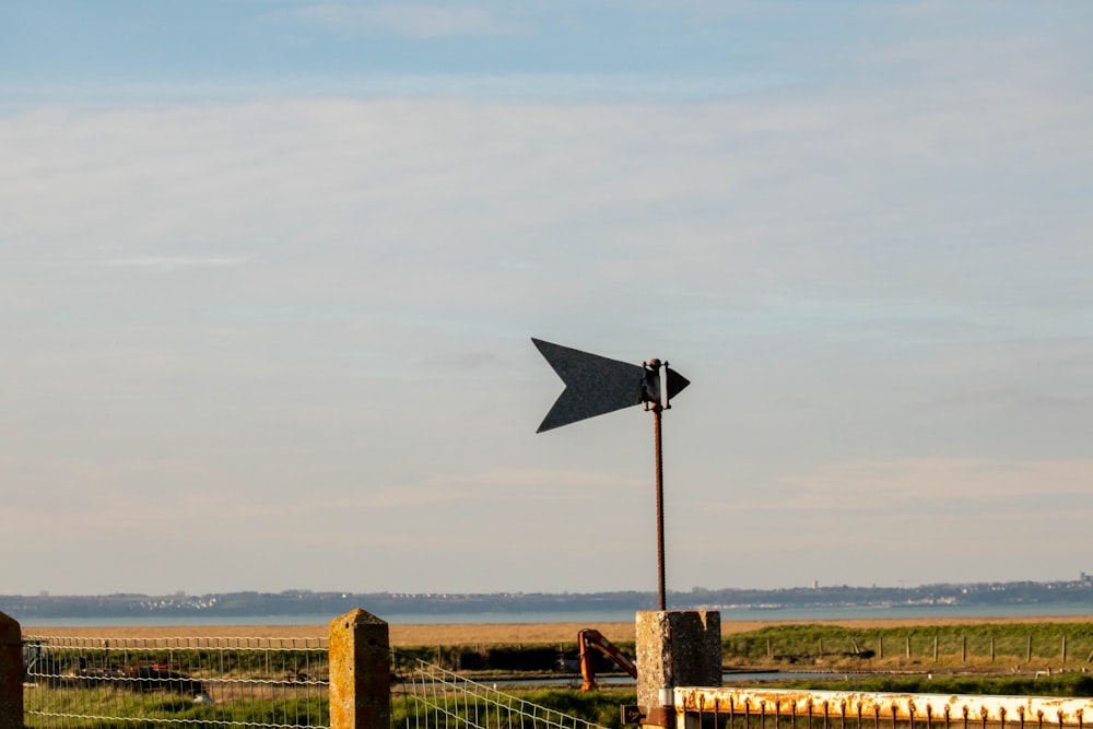 a wind indicator on a post in a field