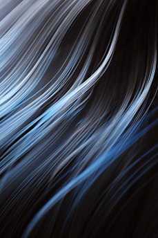 a black and blue background with white streaks