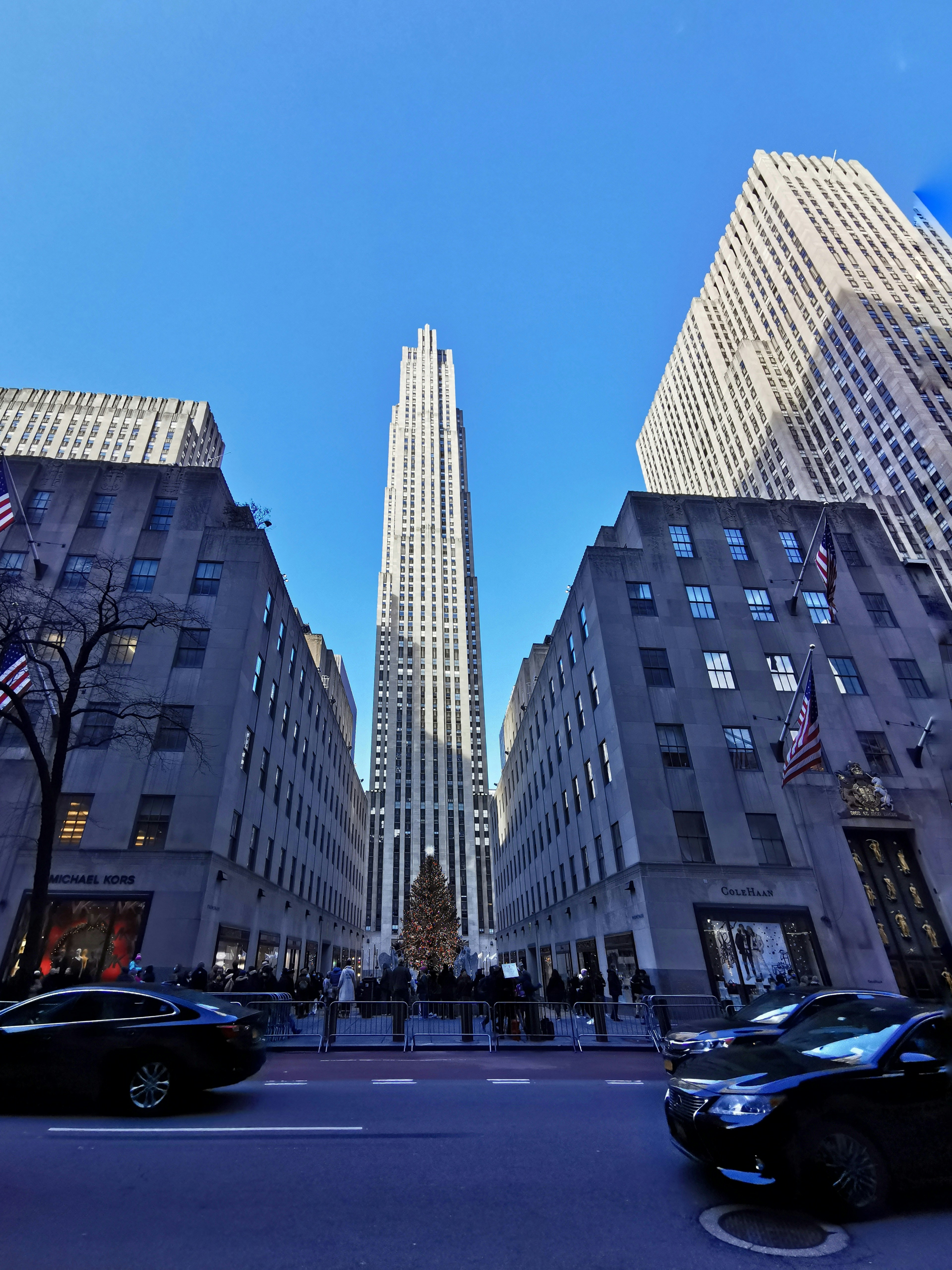 Un edificio molto alto che domina una città piena di traffico