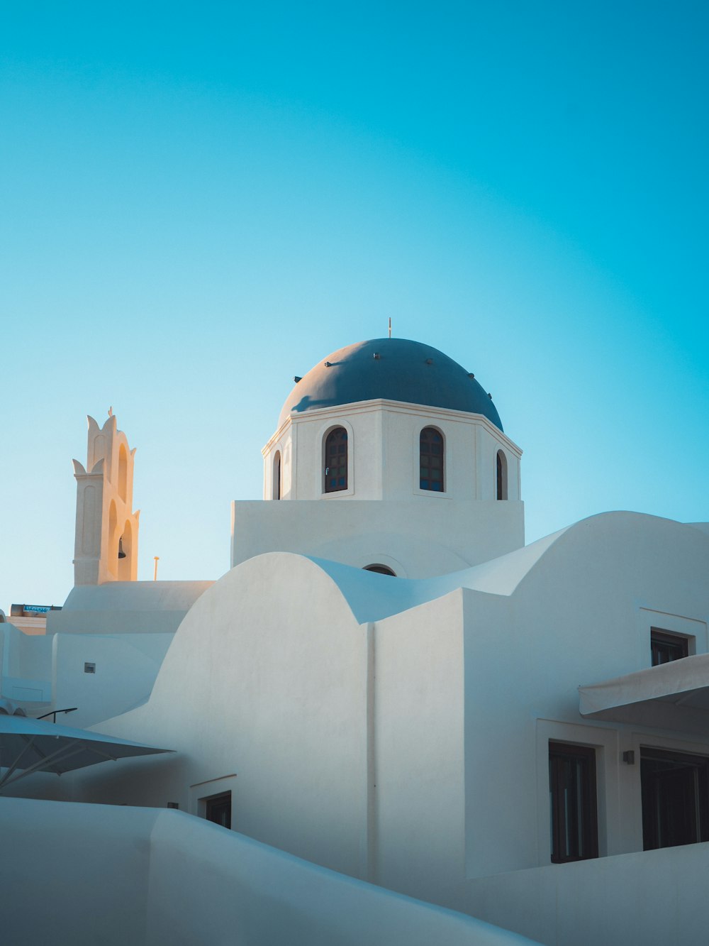 a white building with a blue dome on top