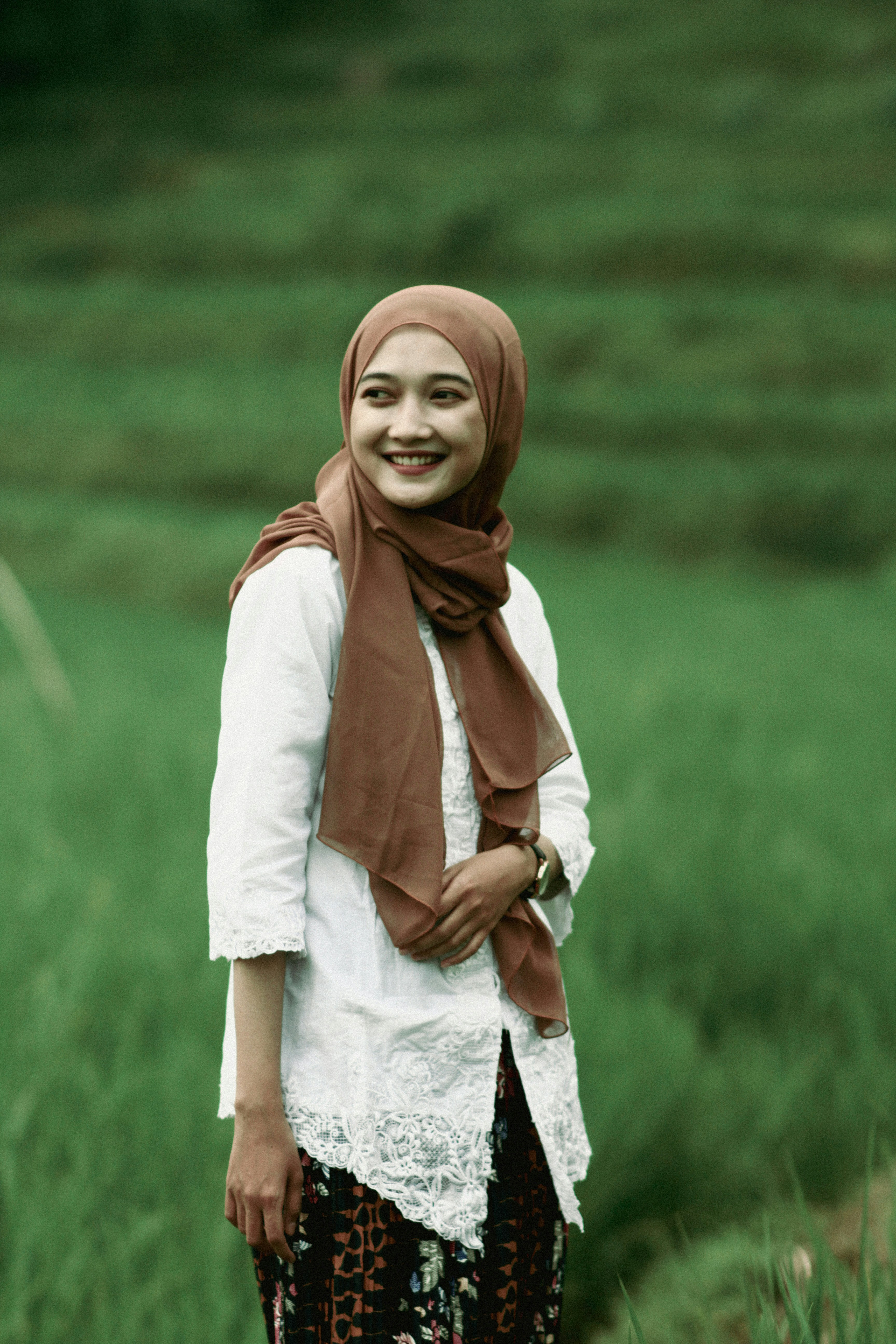 Portrait of Amina Hassan smiling warmly in traditional hijab