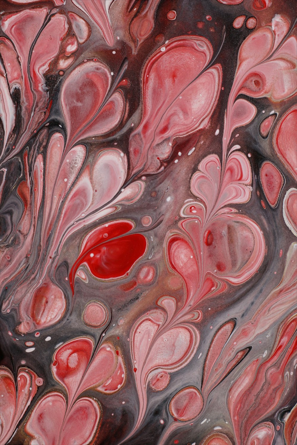 a close up of a red and black abstract painting
