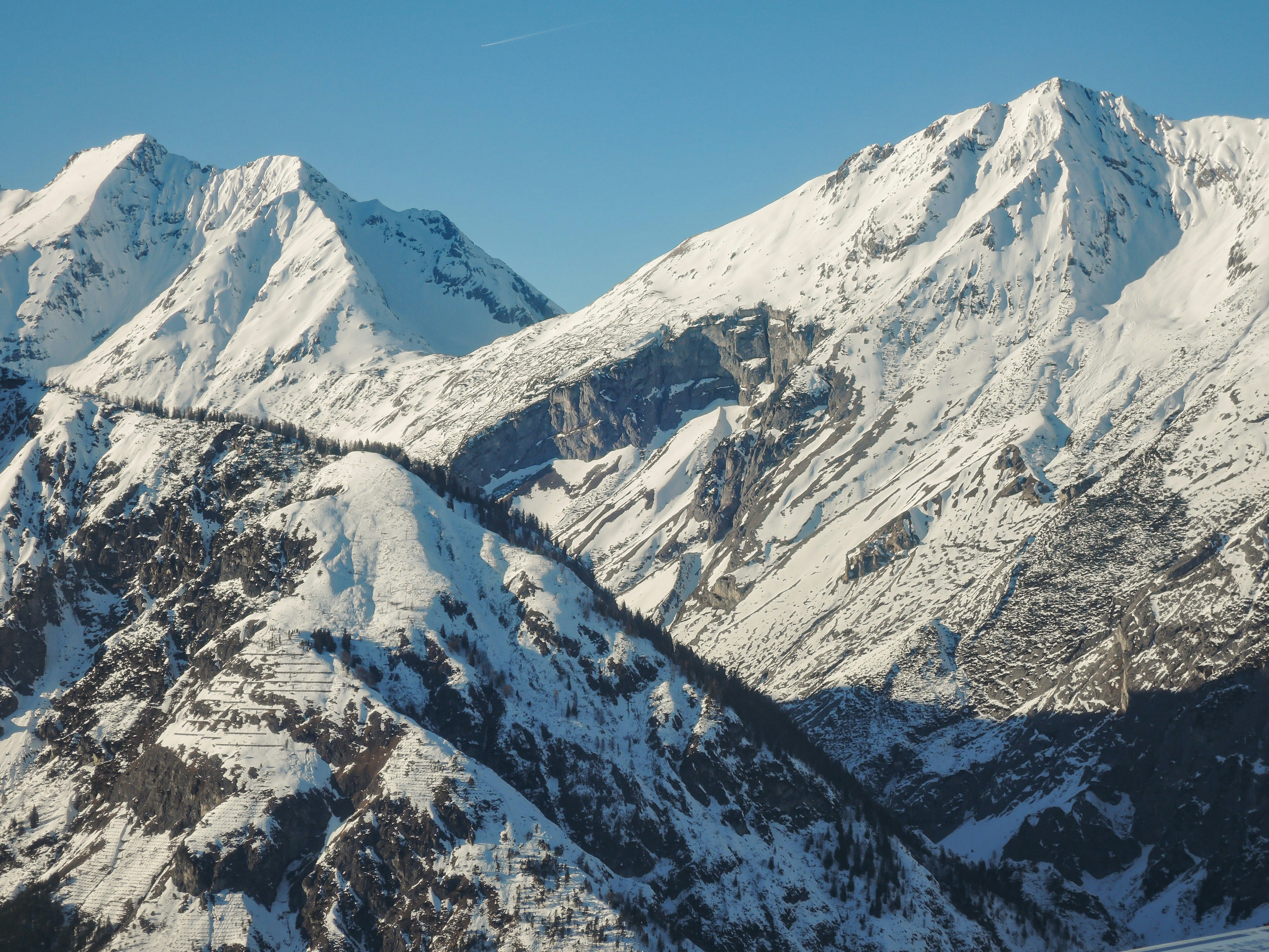 a snow covered mountain range with a clear blue sky