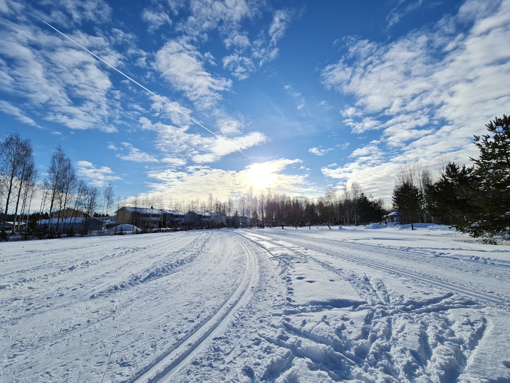 a snow covered road with a sky background