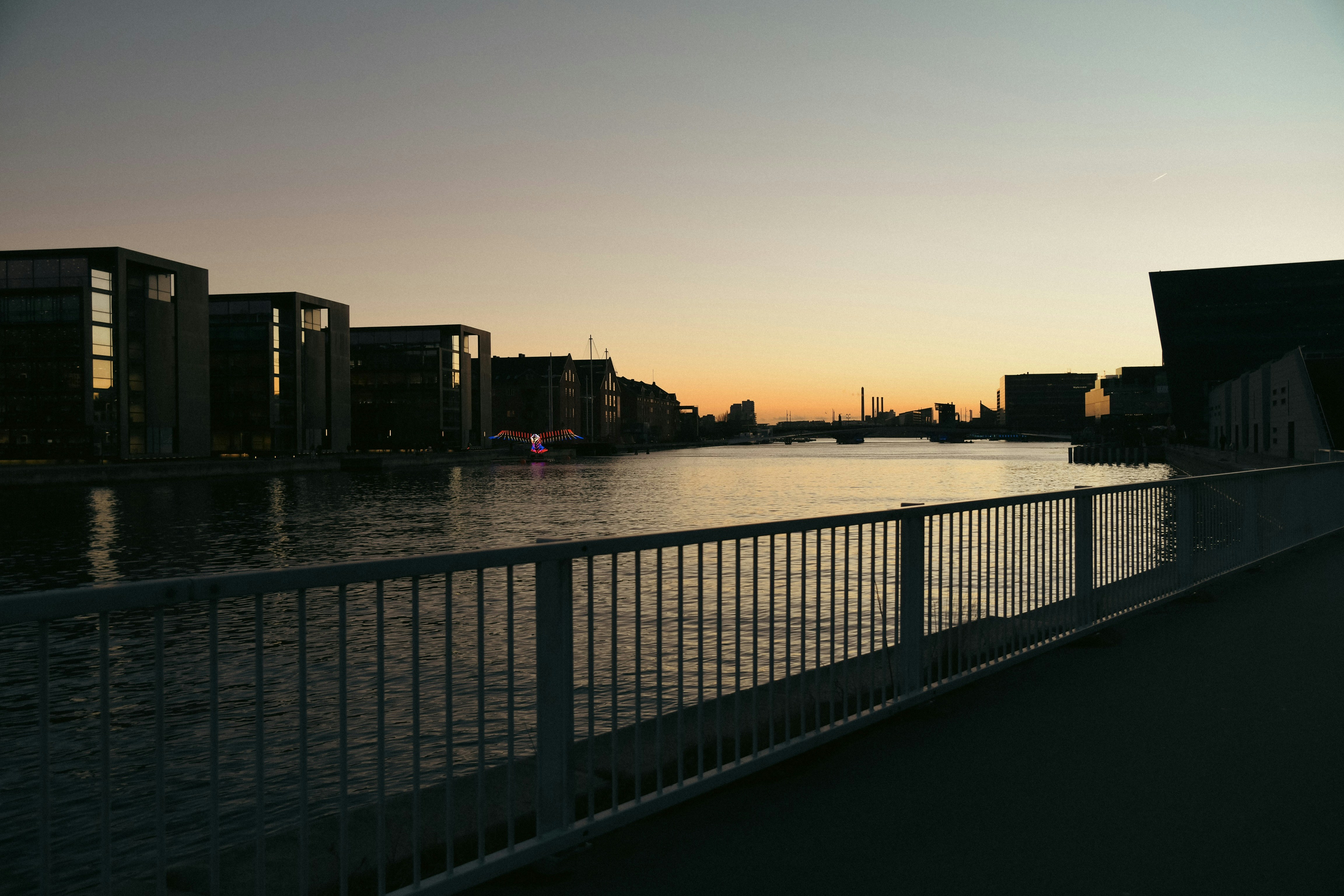 a view of a body of water with buildings in the background