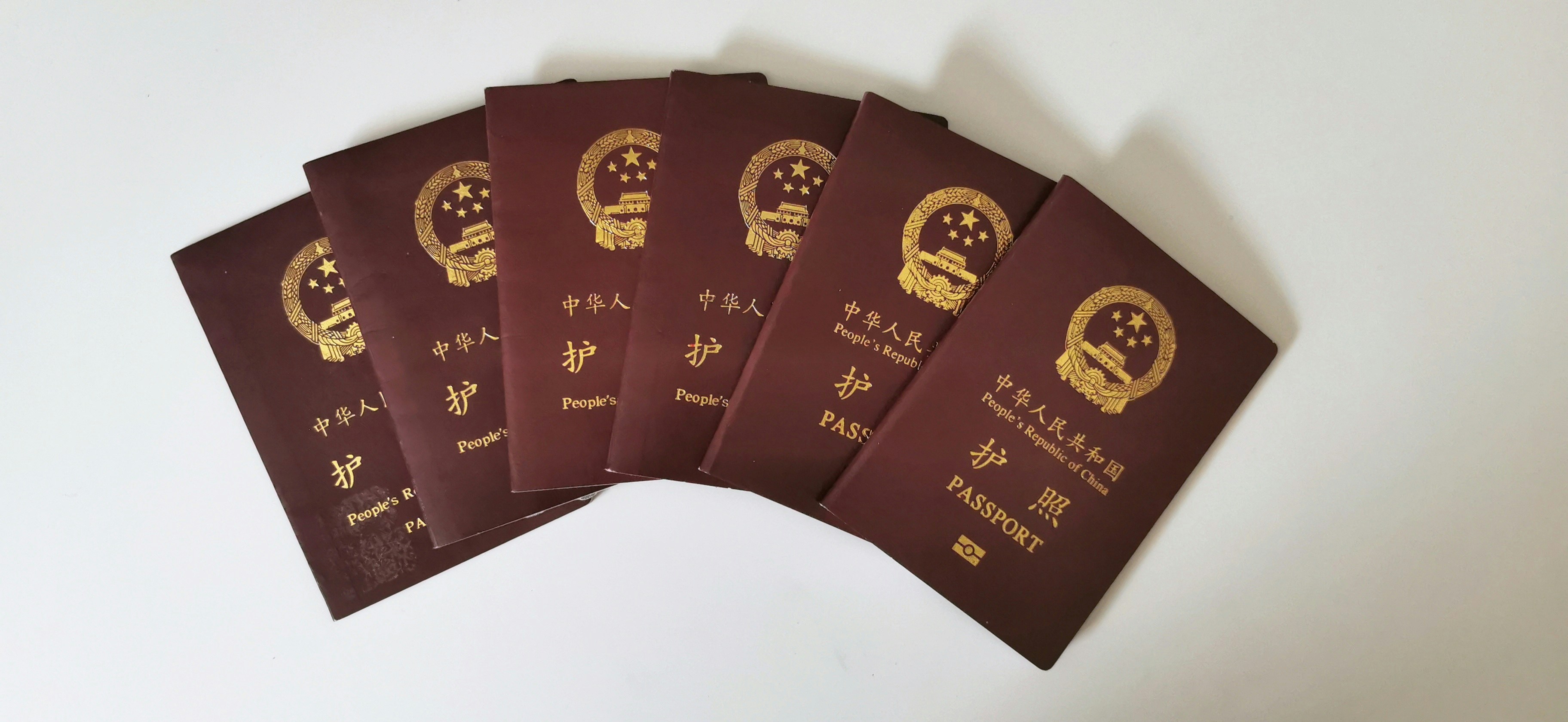 a set of five chinese passports sitting on top of each other