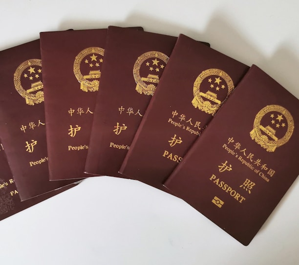 a set of five chinese passports sitting on top of each other