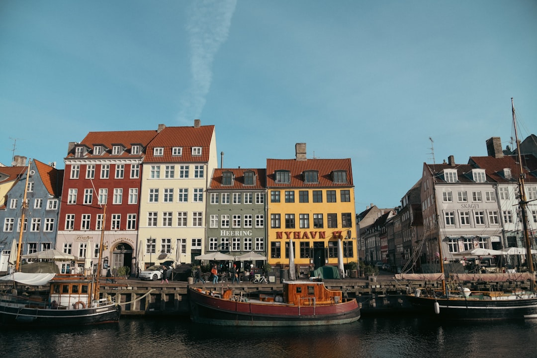 a row of buildings next to a body of water,