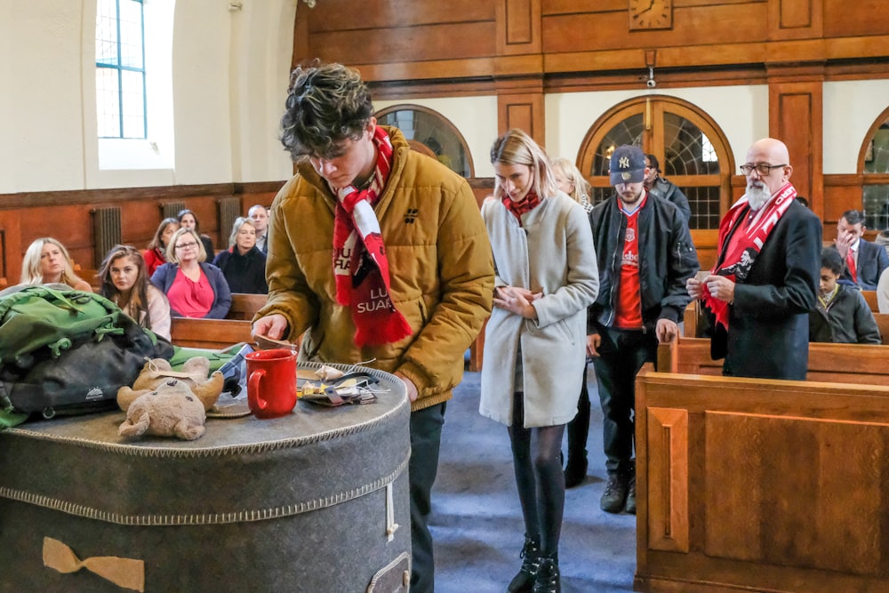 a group of people standing around a table