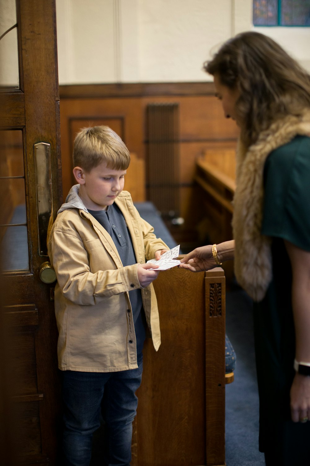 a woman standing next to a boy in a courtroom