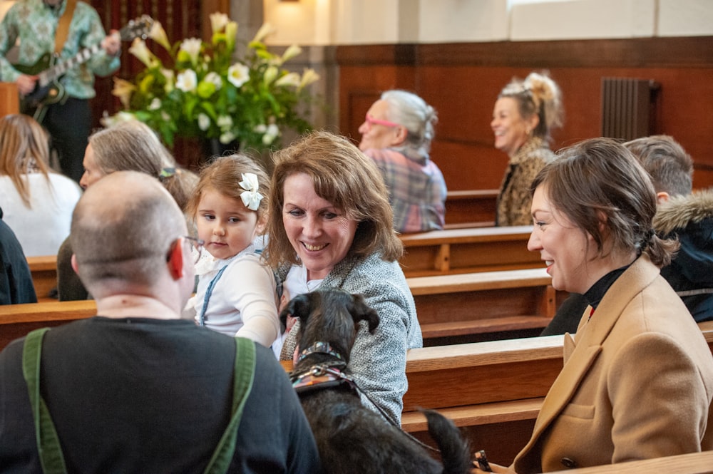 a group of people sitting in pews with a dog