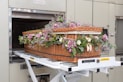 a wicker basket with flowers in it on a conveyor belt