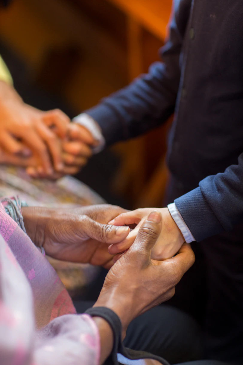a group of people putting their hands together
