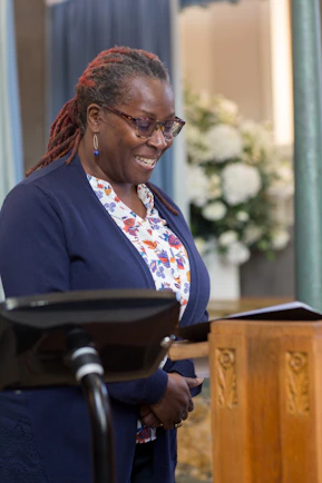 a woman standing in front of a wooden podium