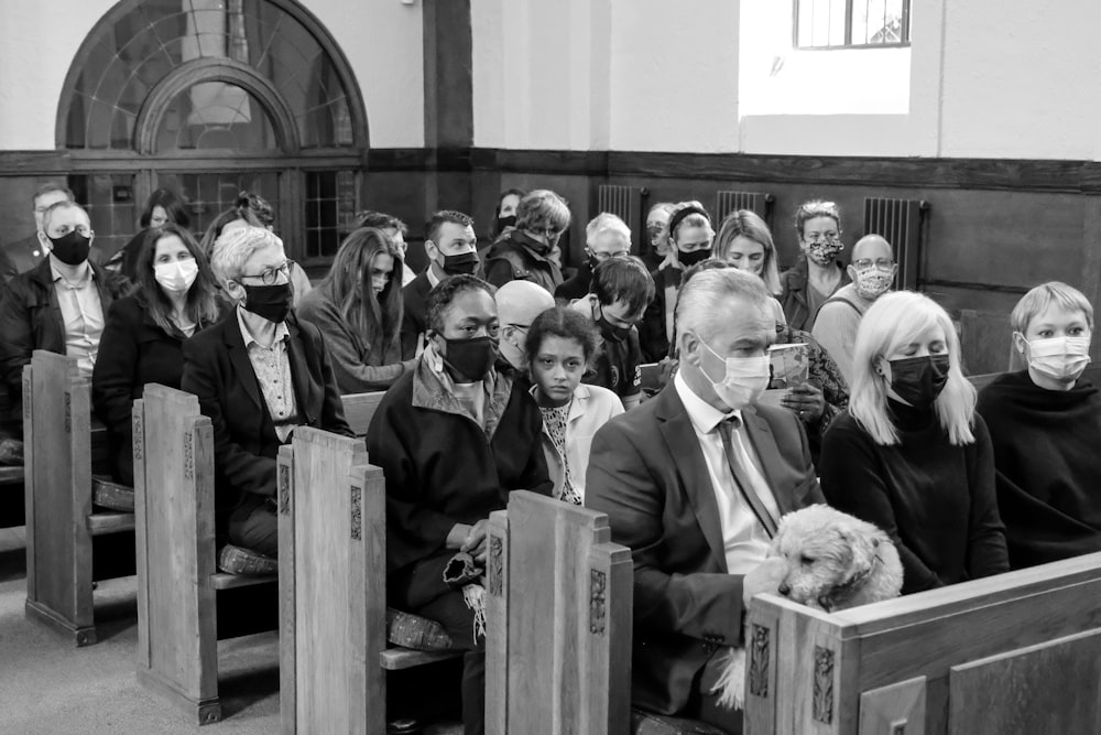 a black and white photo of a group of people wearing masks