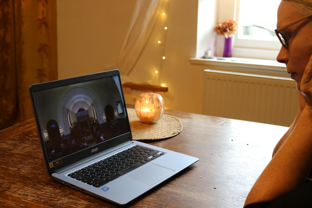 a woman sitting in front of a laptop computer