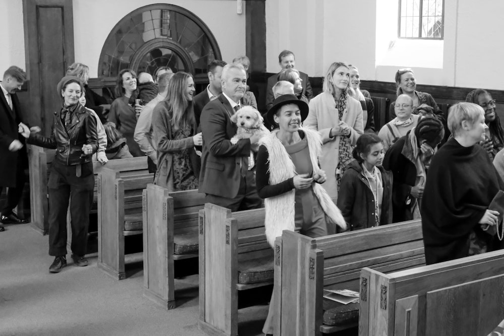 a black and white photo of people in a church