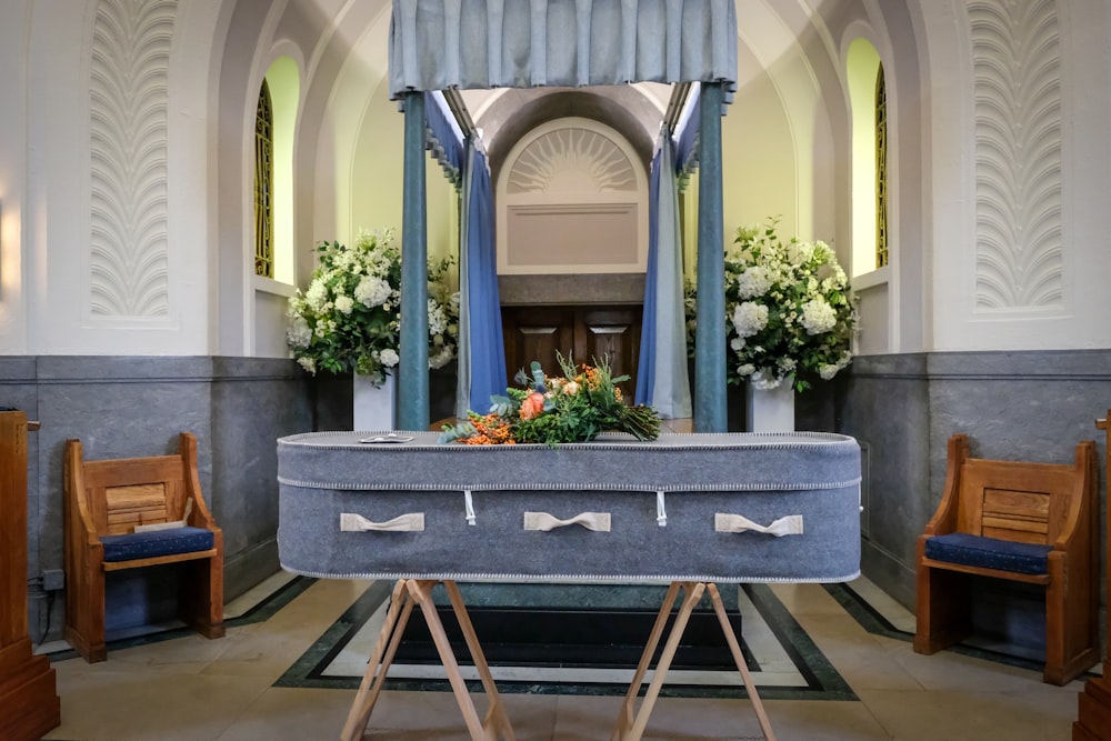 a church with a pew and flowers on it