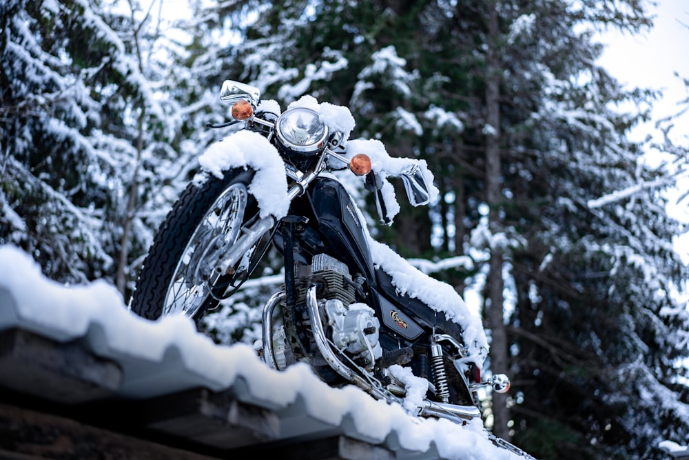 a motorcycle parked on top of a snow covered roof