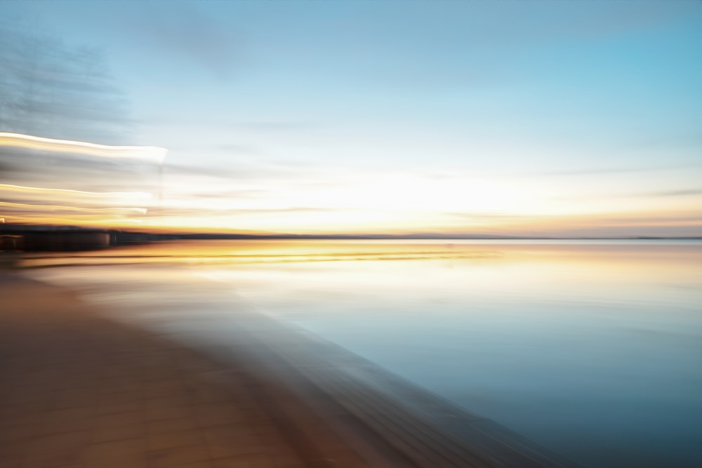 a blurry photo of a beach at sunset