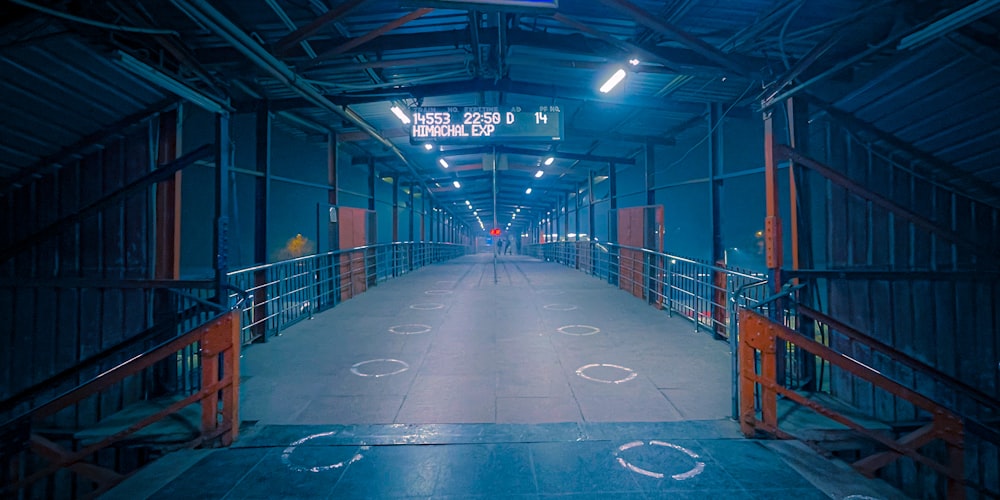 a walkway in a building with a sign on it