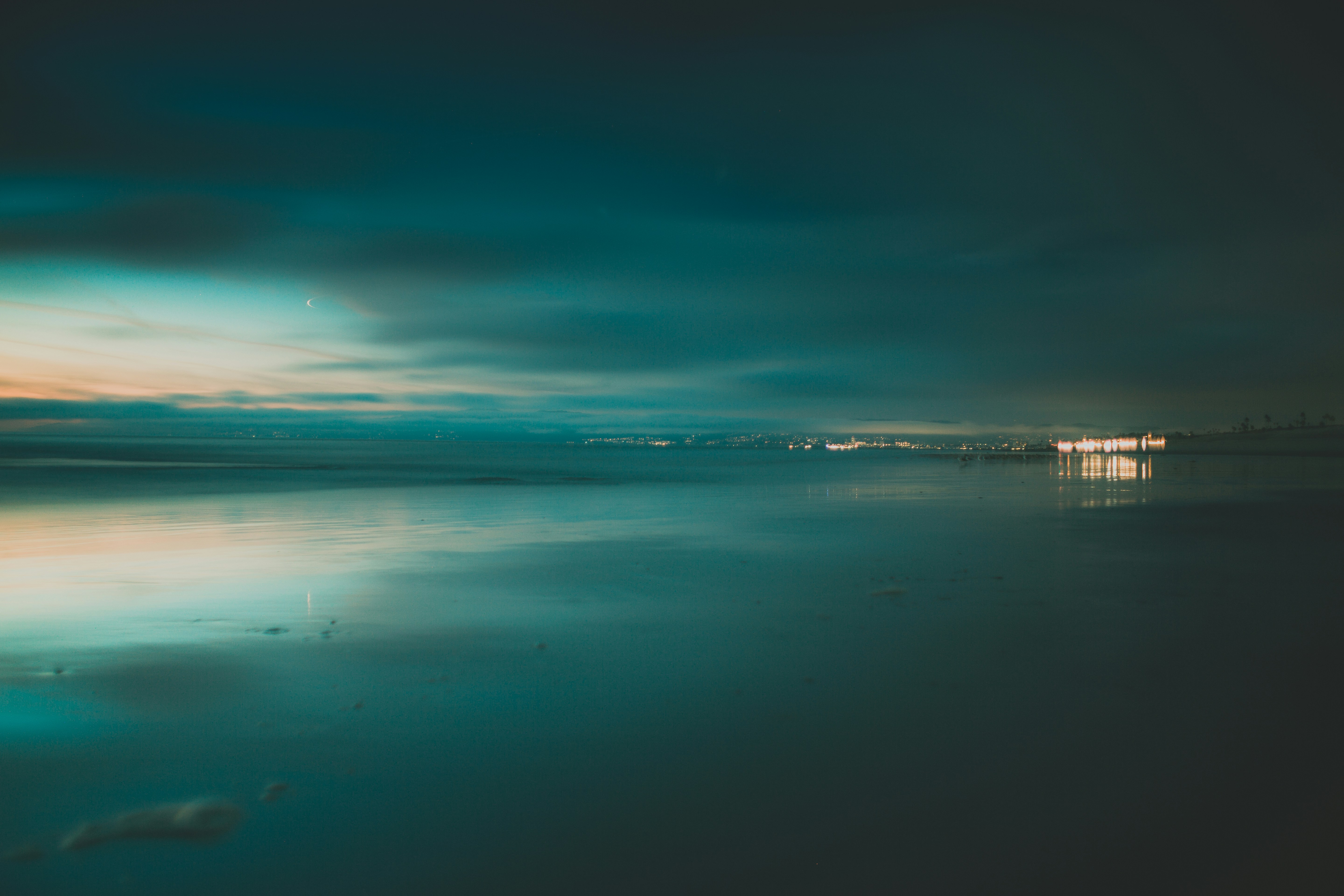 A view of a body of water at night photo Free Ocean Image on Unsplash