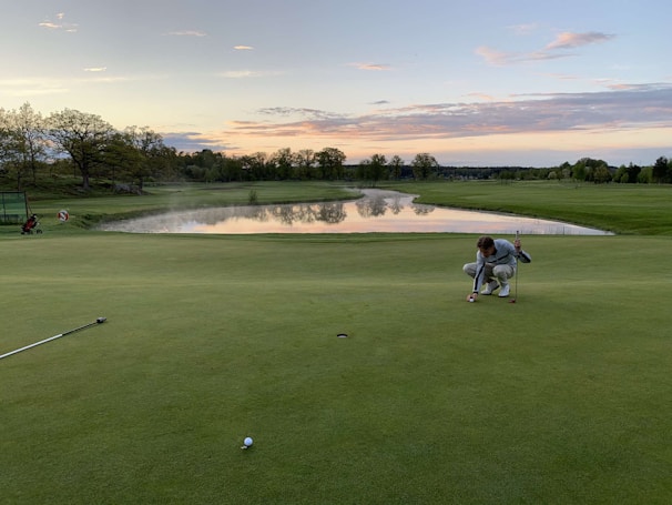 Players lining up their putts on a smooth green during a community golf event.