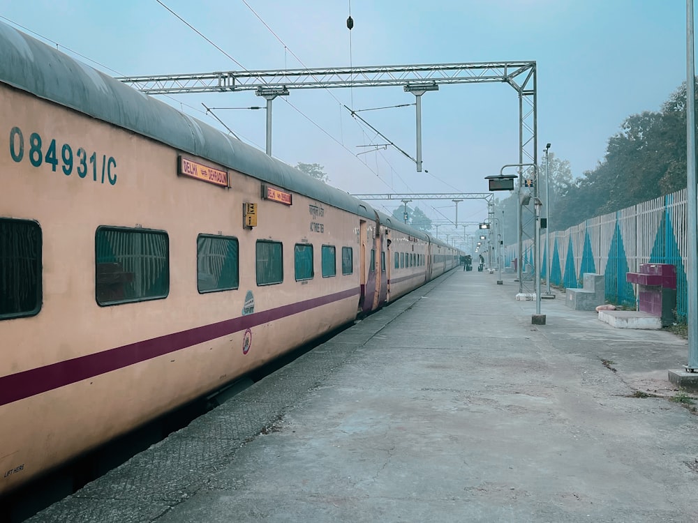 a train parked at a train station in the fog