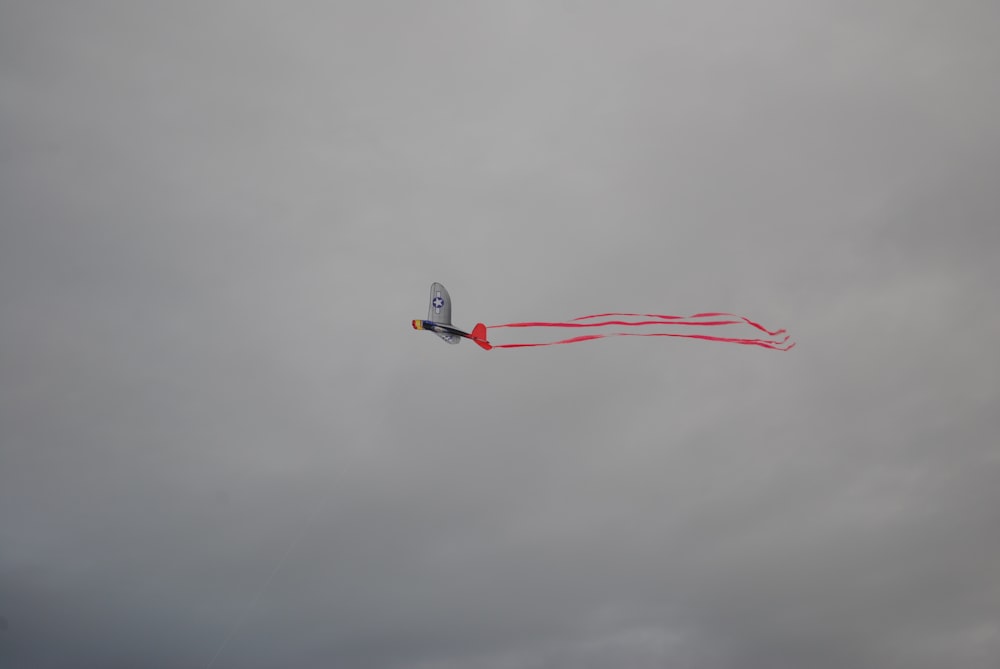 a kite flying in the sky on a cloudy day
