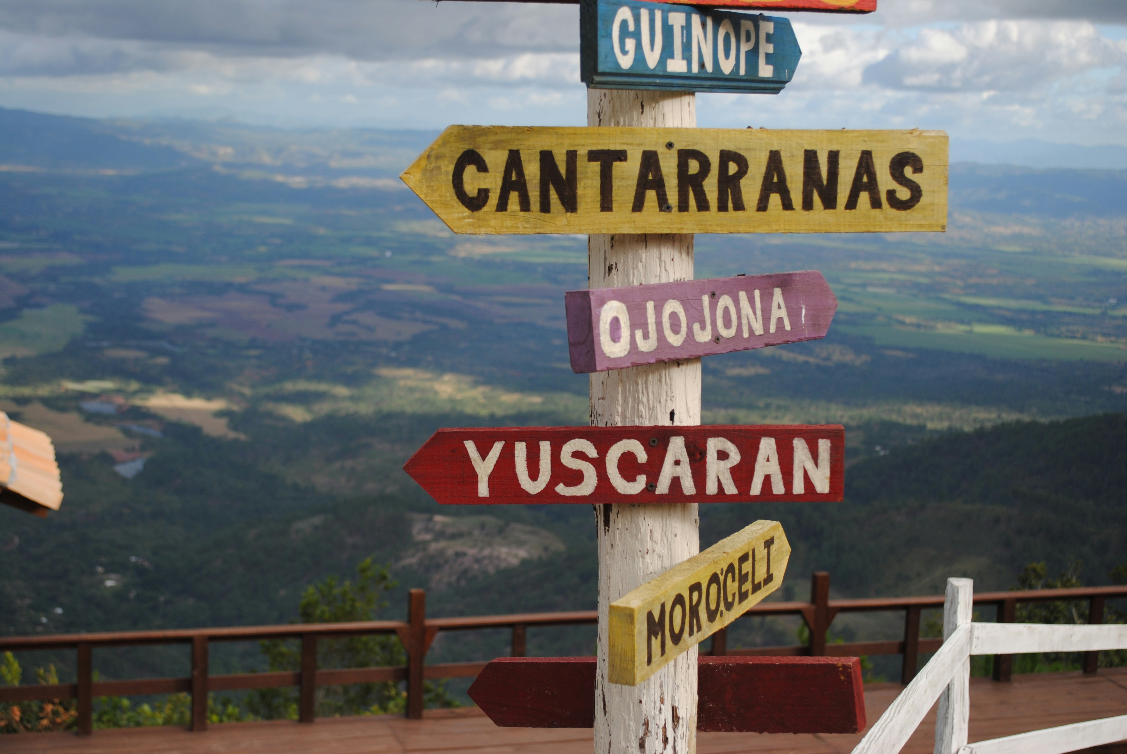 woman wearing yellow long-sleeved dress under white clouds and blue sky during daytime