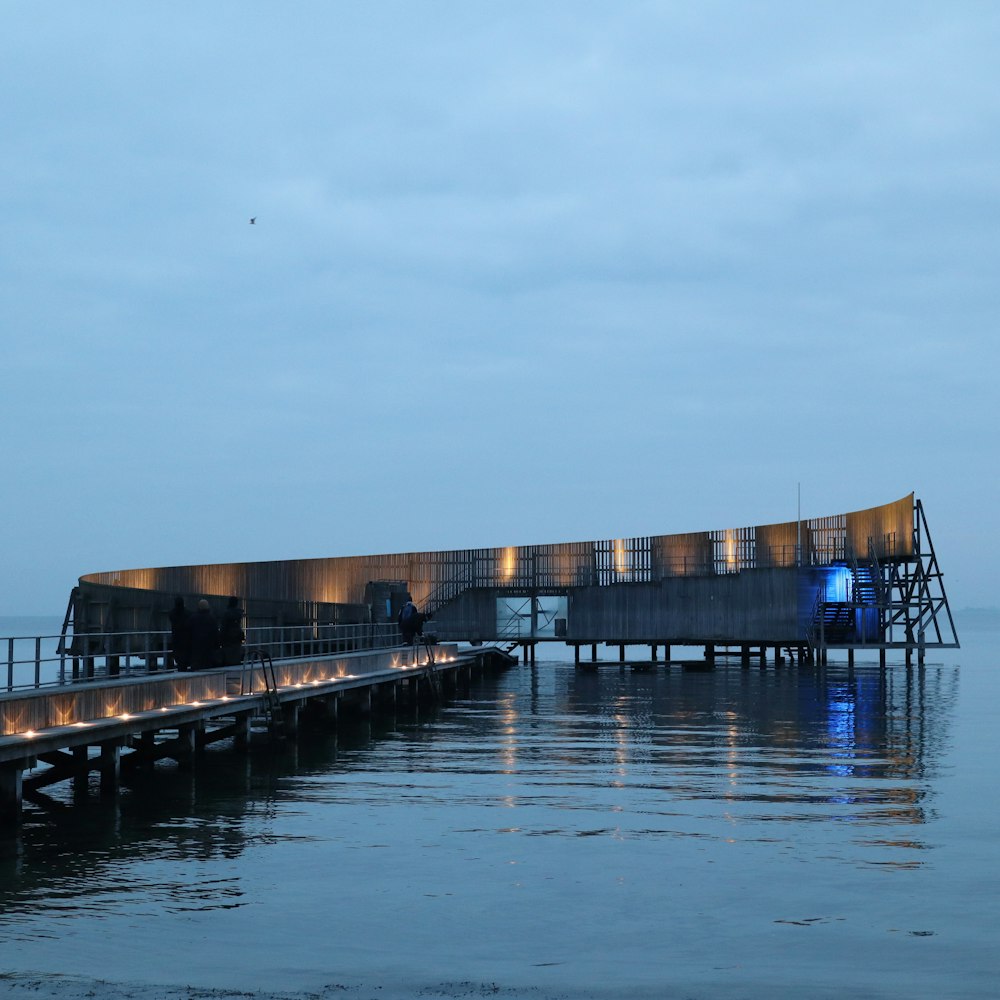 a pier with a lit up structure on it