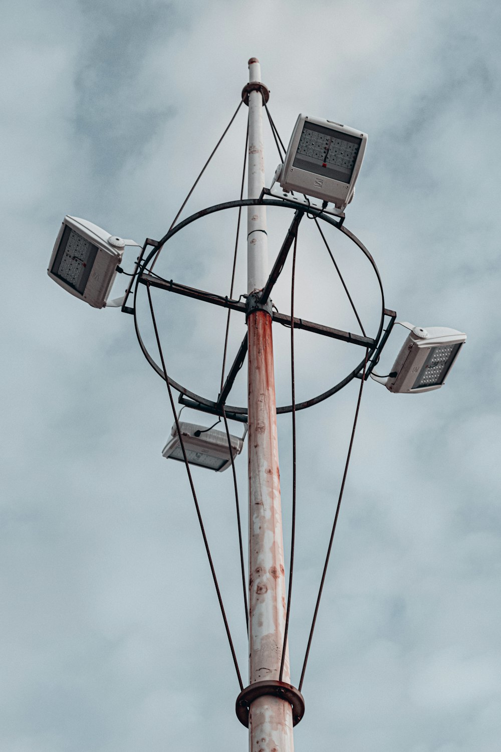 a street light with four lights on top of it