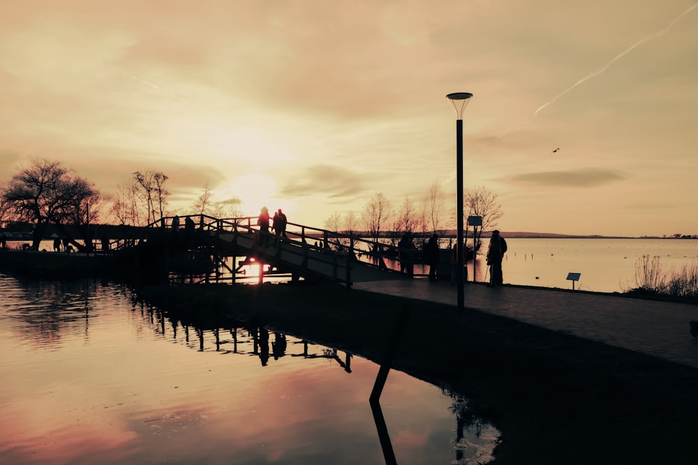 a person walking across a bridge over a body of water