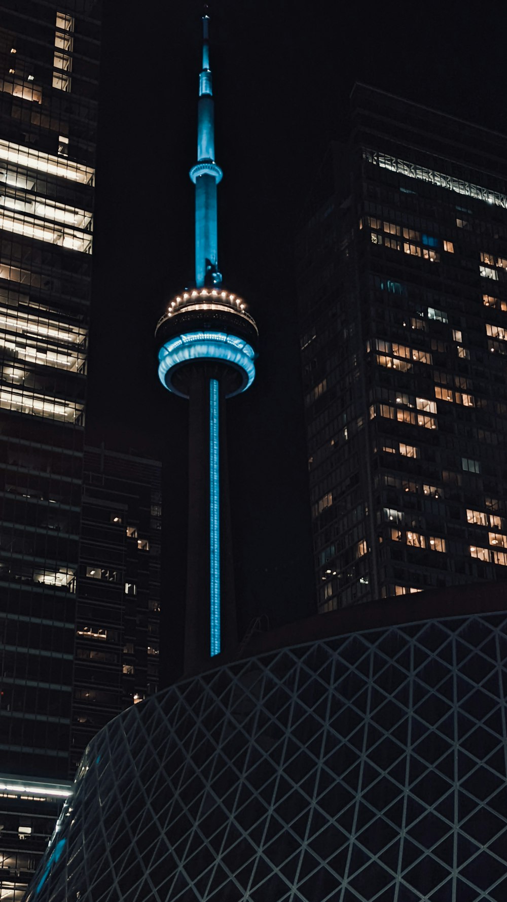 a very tall building with a blue light on it's side