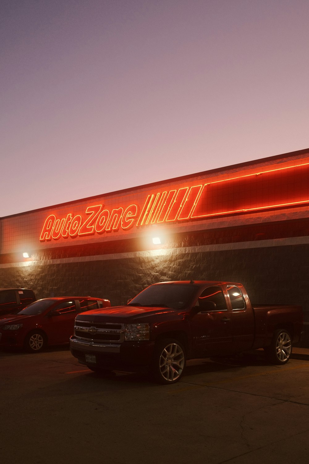 a red truck parked in front of a store