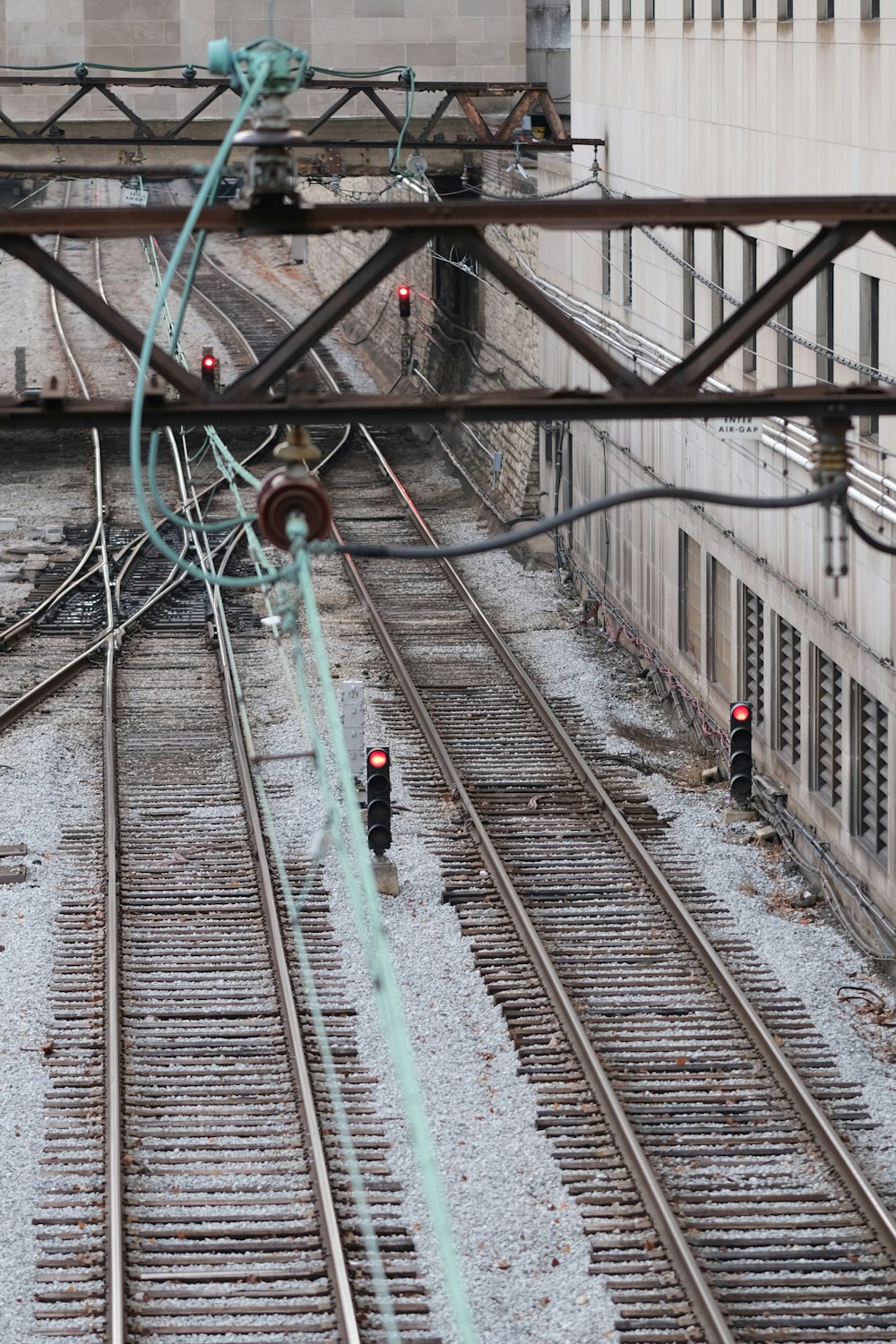 an overhead view of a train track with a building in the background