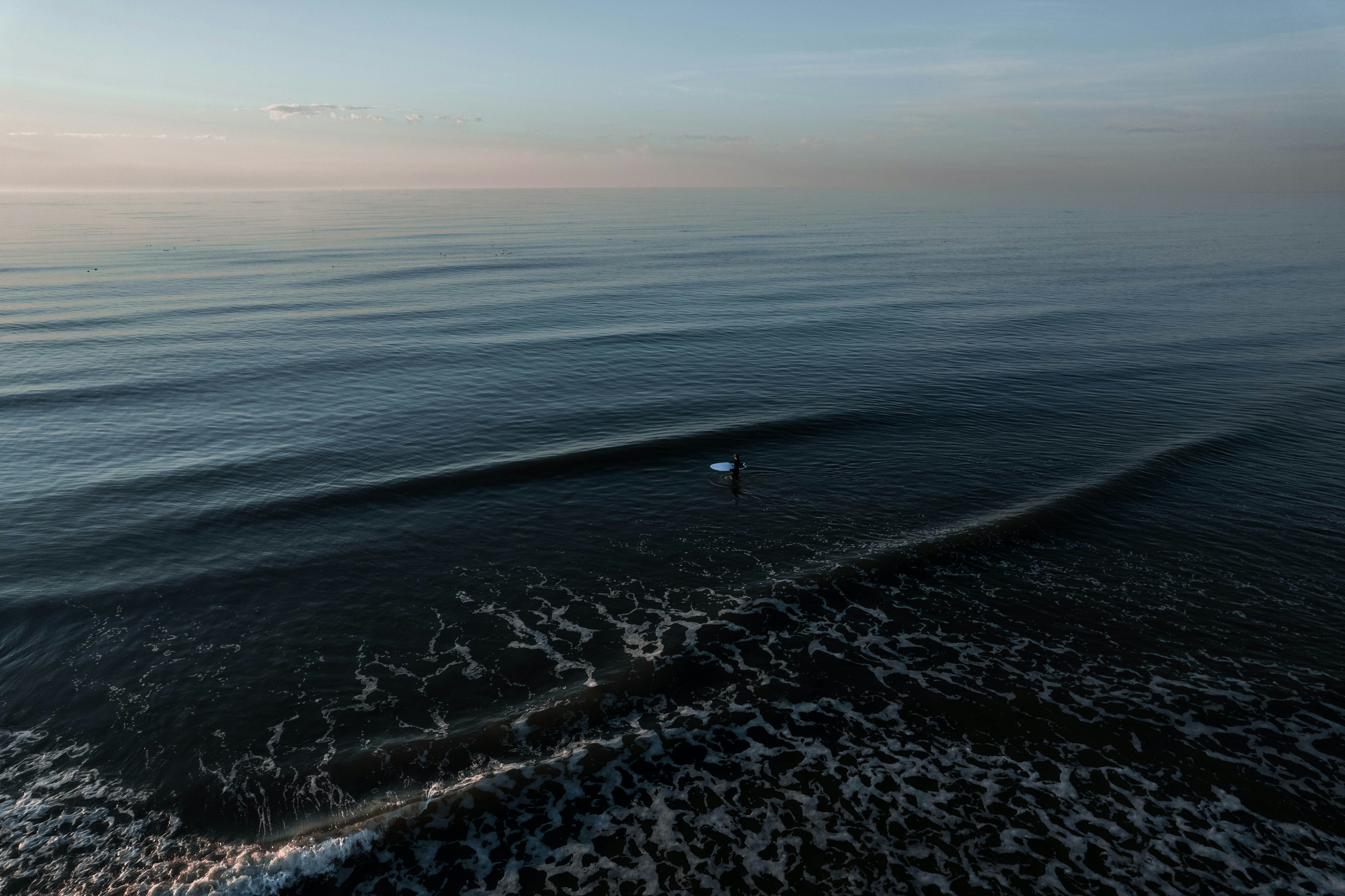 a person riding a wave on top of a surfboard