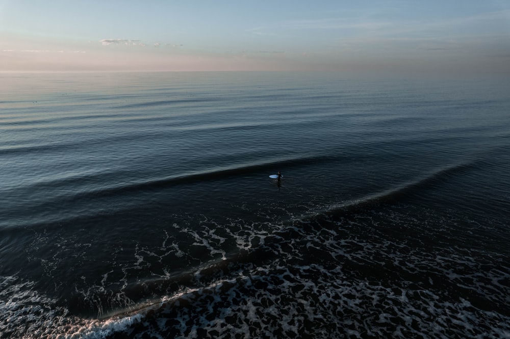 a person riding a wave on top of a surfboard