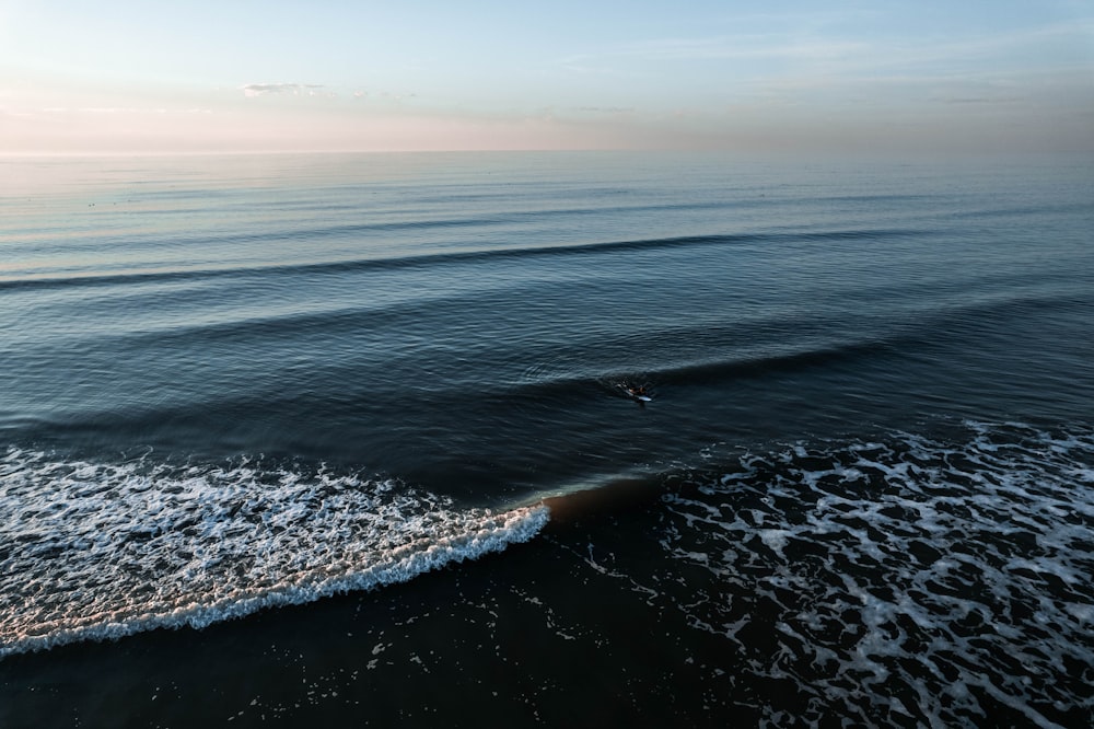 a large body of water with waves coming in to shore