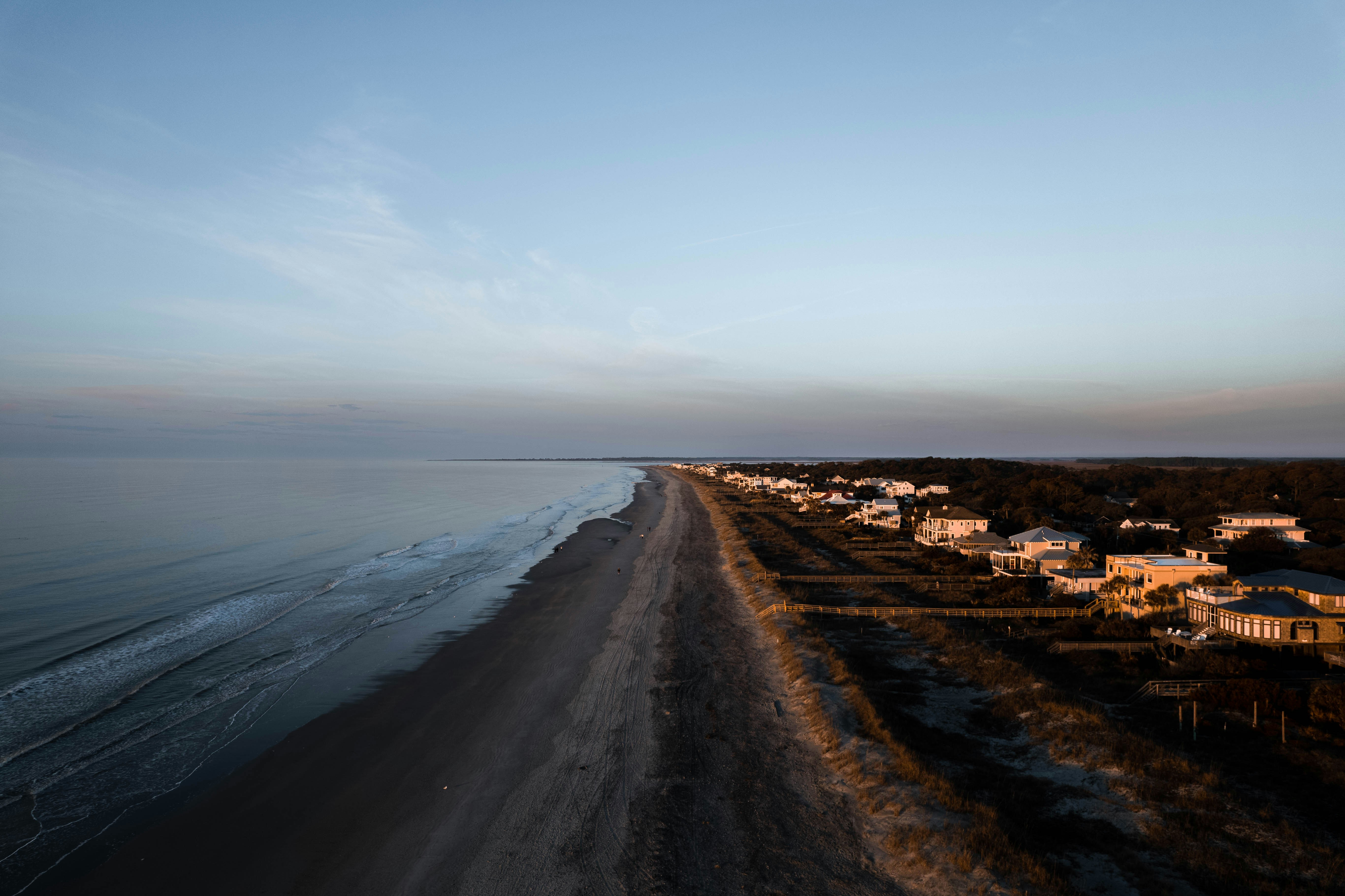 a long stretch of beach next to the ocean