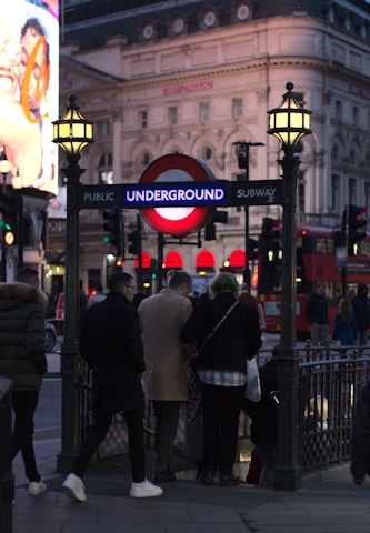 a group of people standing under a street sign