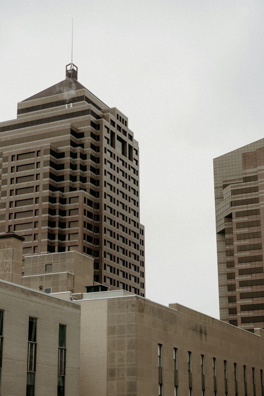 a couple of tall buildings sitting next to each other