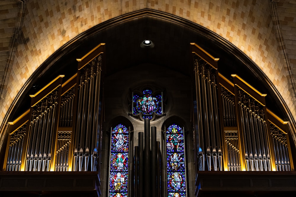 a large pipe organ in a church with stained glass windows