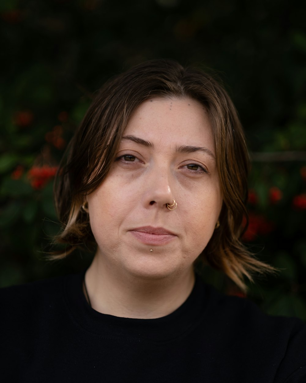 a close up of a person with a nose piercing