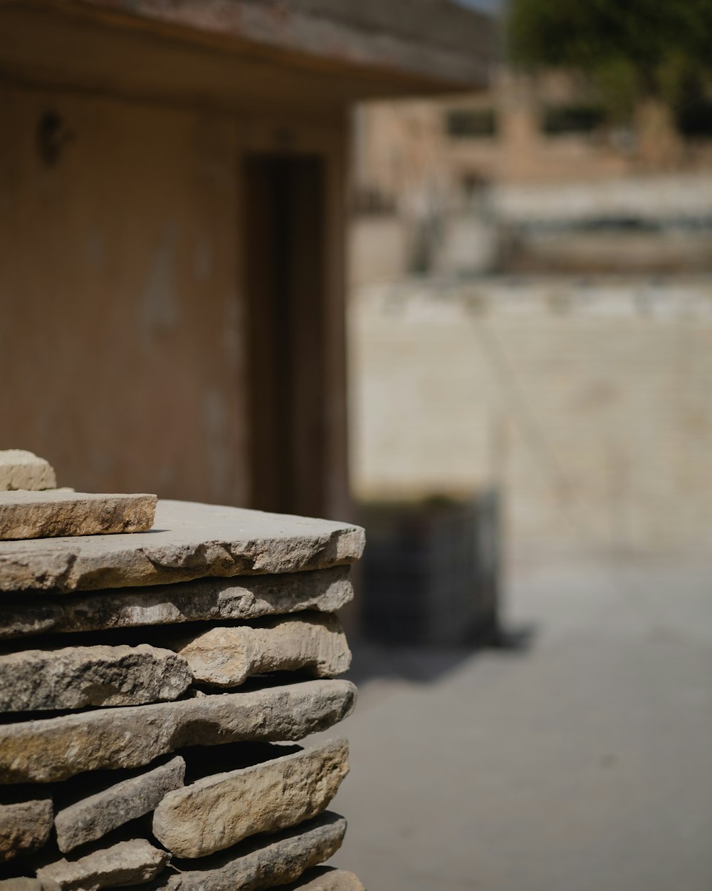 a stack of rocks sitting next to a building