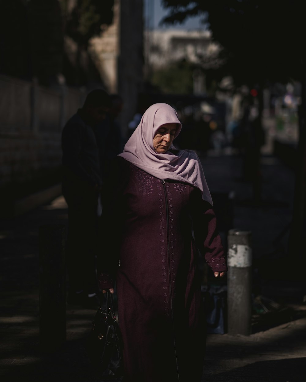 a woman in a hijab walking down the street
