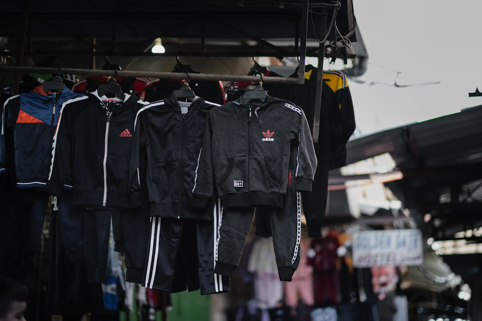 Rack of matching tracksuit jackets and joggers hanging together, ready for apparel sourcing and wholesale