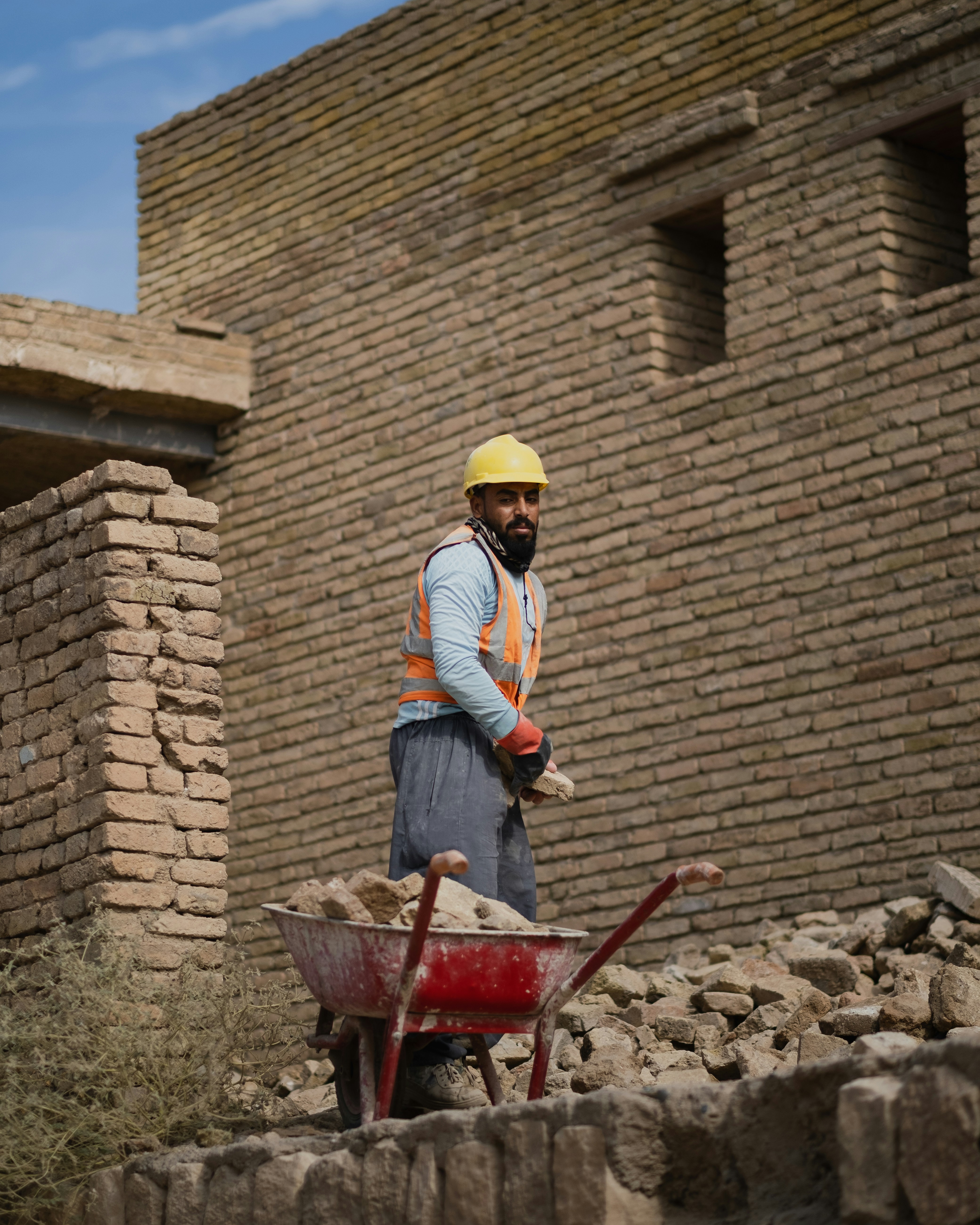 a man standing next to a pile of rubble